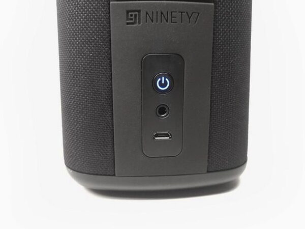 A close-up of the Vaux's front control panel showing the Ninety7 logo, power button, aux jack, and micro-USB port