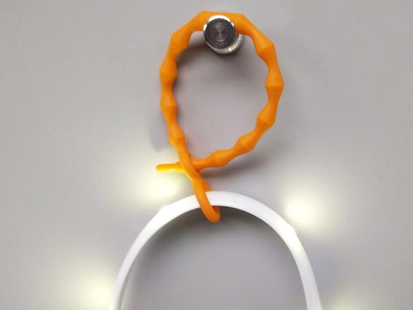 One of the Luminoodle's orange mounting ties looped around the light rope
