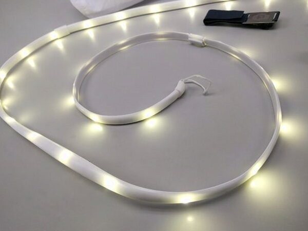 The Luminoodle light rope coiled and lit on a tabletop