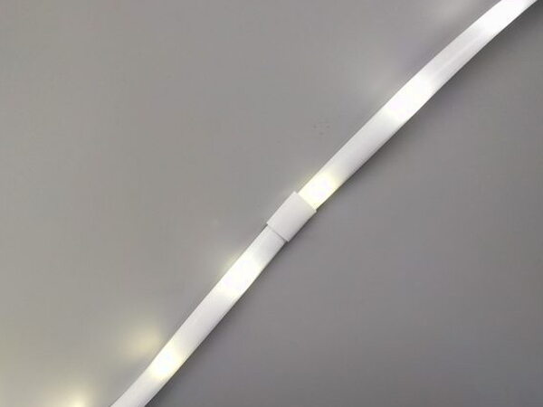 The Luminoodle light rope lit up and laid out with a joint connector visible