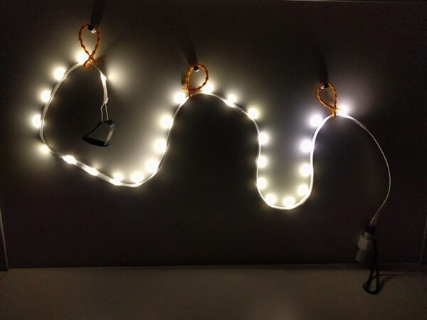 The Luminoodle light rope glowing brightly against a dark background