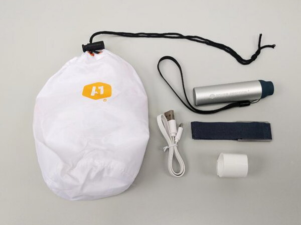 The Luminoodle's nylon carrying bag, battery pack, cable, and magnetic sleeve laid out together