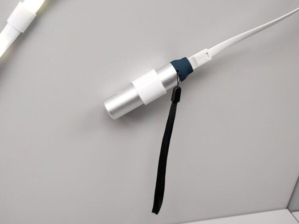 A close-up of the Lithium 3400 battery pack's cable connection and wrist strap