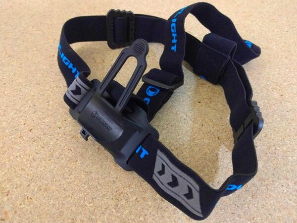 The Olight H2R Nova headstrap mount on its own, unclipped and laid flat