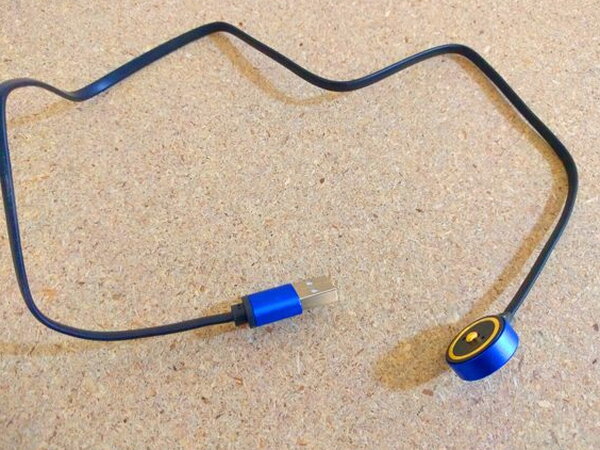 The magnetic charging cable on its own, USB-A on one end and a magnetic tip on the other