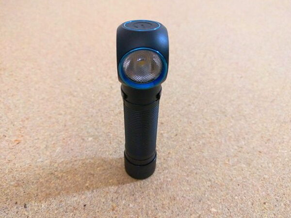 A head-on view of the Olight H2R Nova lens and power button