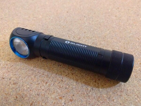 The assembled Olight H2R Nova from a three-quarter angle showing the angled head and blue accent ring
