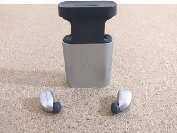 The Skybuds case and earbuds in the same flat lay shot used throughout testing