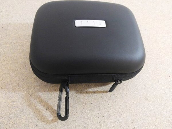 The FIIL CANVIIS Pro closed case with a carabiner clip attached to the zipper pull