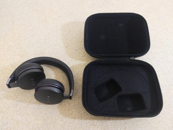 The FIIL CANVIIS Pro next to its open case with molded foam shaped to fit the earcups