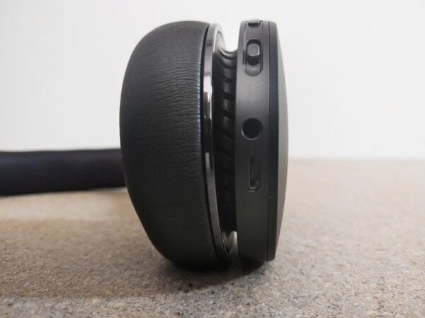 The FIIL CANVIIS Pro right earcup edge showing the power switch, aux jack, and charging port
