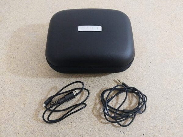 The FIIL CANVIIS Pro case with both included cables laid out in front of it