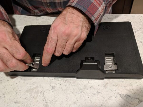 Hands positioning a LOOK-IT mounting bracket