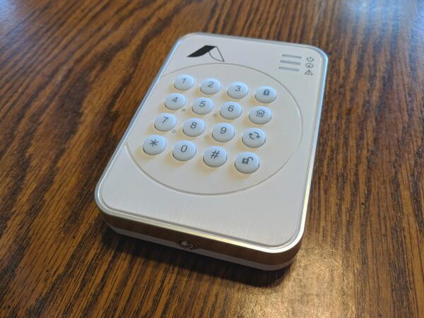Abode Wireless Keypad lying face up on a table