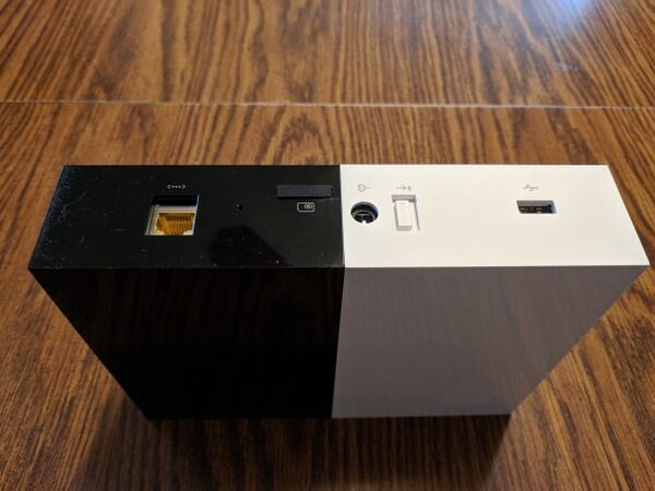 Rear panel of the Abode Gateway showing Ethernet, USB, battery switch, SIM slot, and power connections