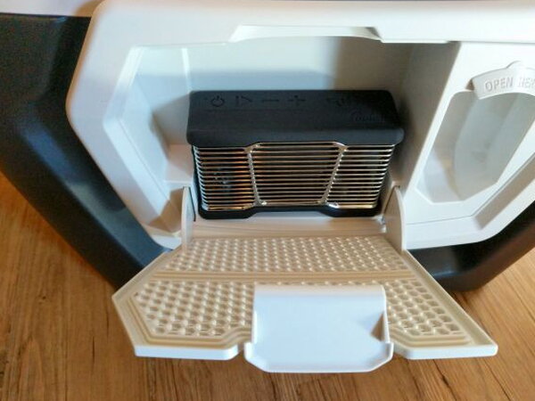 Speaker storage compartment open