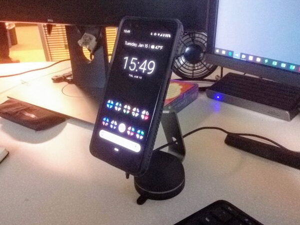 Phone mounted on the MagBuddy Desktop charger at a desk