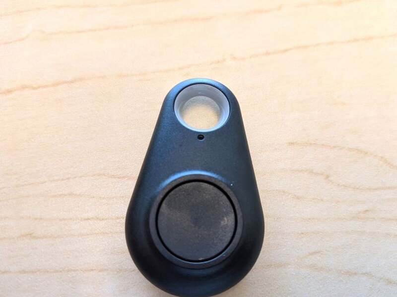 A close look at the remote face, button, keyring hole, and status indicator.