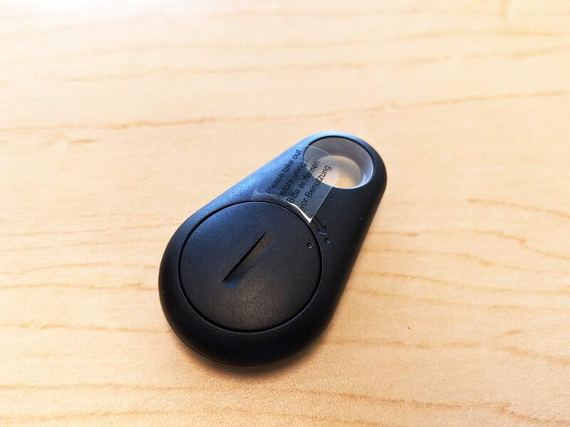 The back of the remote shows the battery door and the plastic pull tab for the included CR2032 battery.