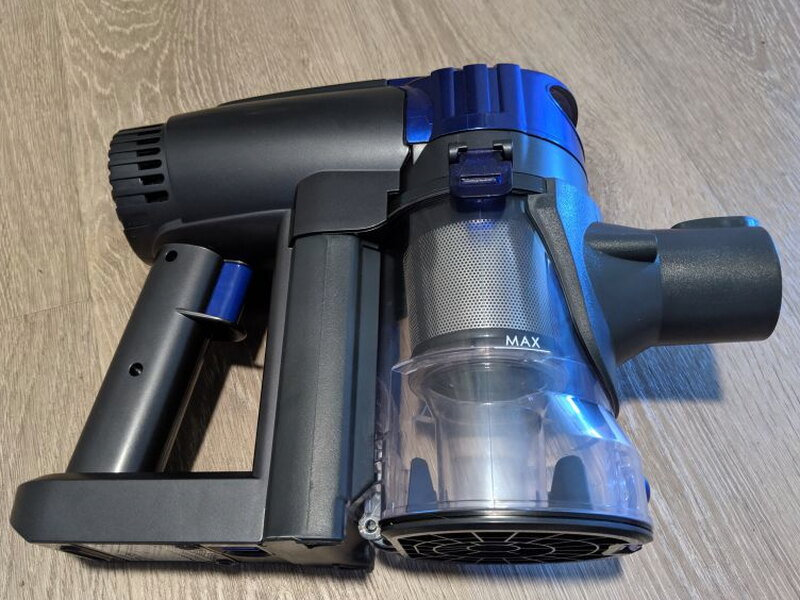 The handheld motor unit and dust container separate into two main sections.