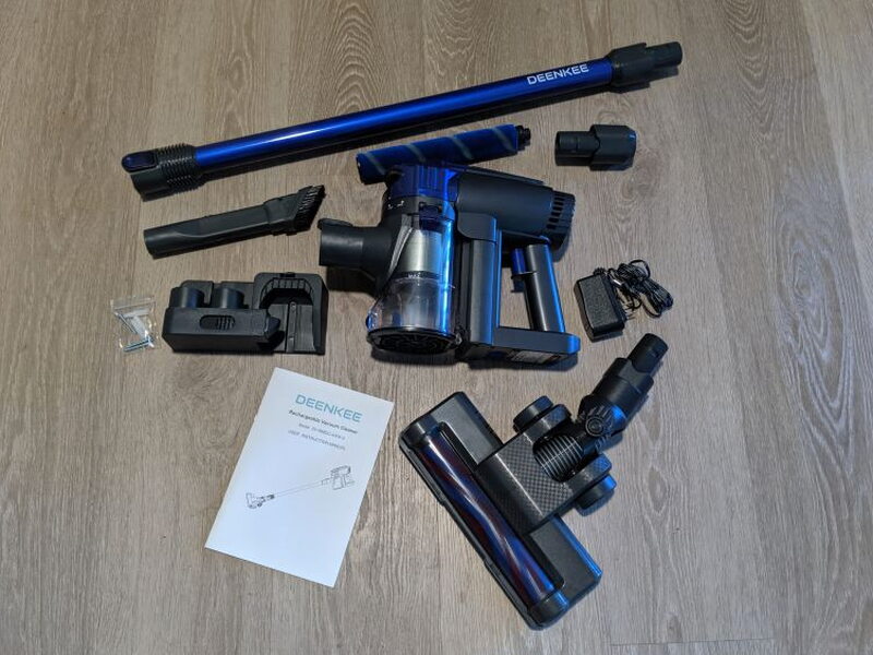 The full kit includes the vacuum body, tube, powered brush, dusting brush, wall mount, adapter, spare roller, and manual.