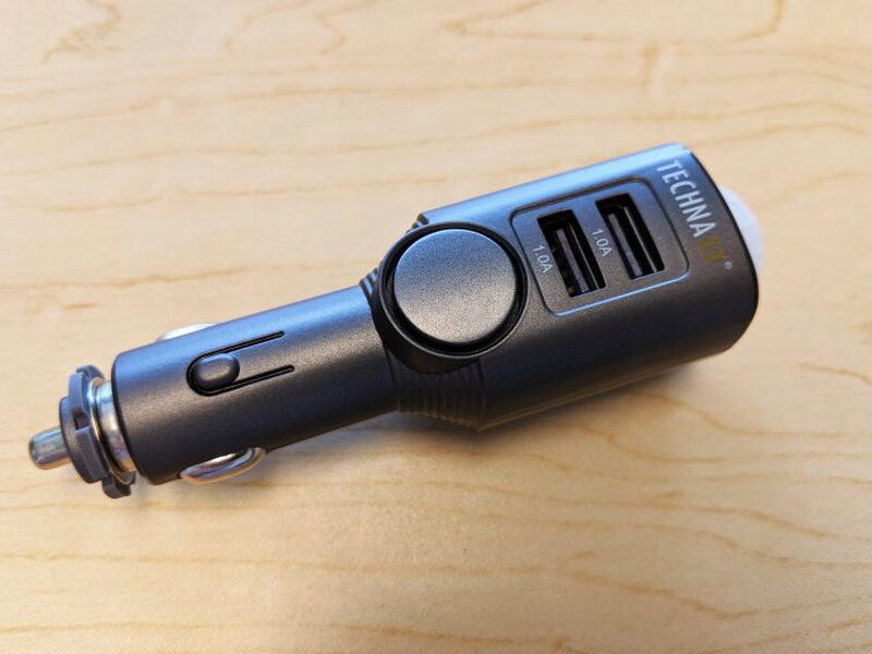 The side of the TX-100 shows the round siren area below the two 1A USB ports.