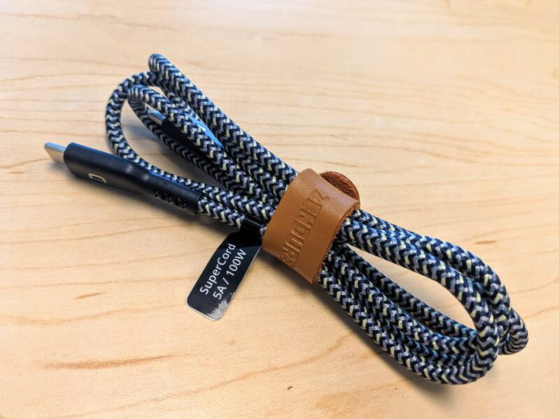 The 100W SuperCord includes a leather strap for keeping the cable bundled.