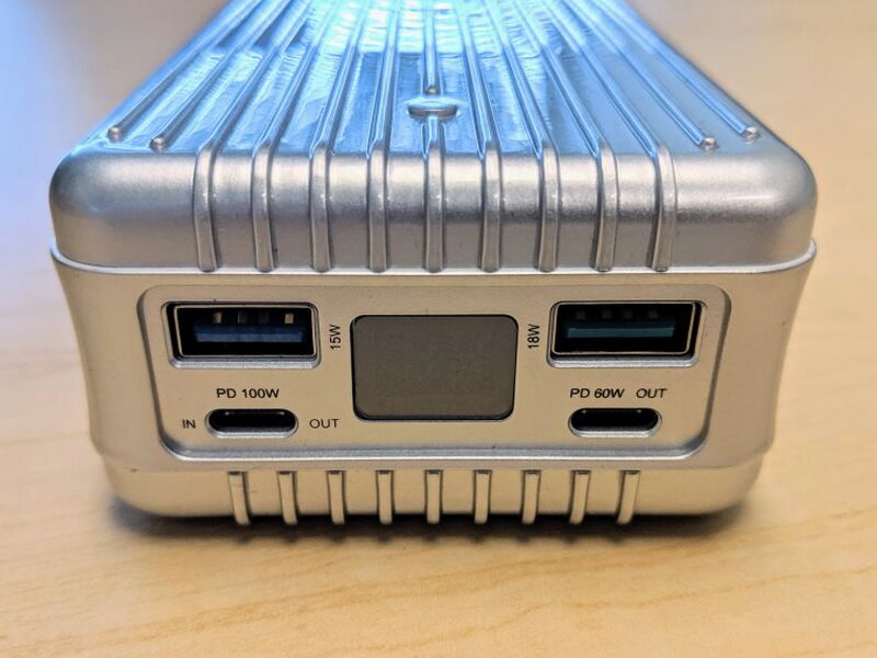 The front face includes the USB-A ports, USB-C ports, and central LED display.