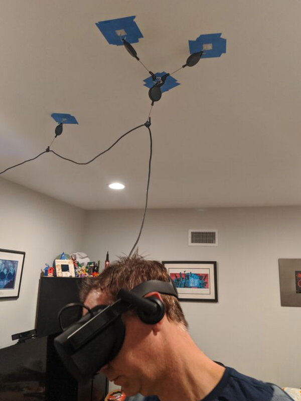 A tester leaning while the overhead pulleys continue to manage cable slack.