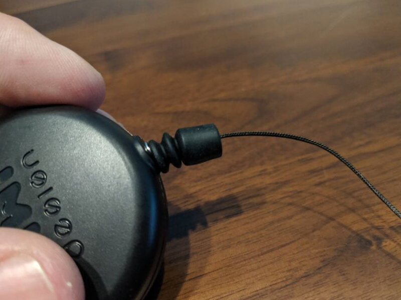 The small adjustment nut on the retractable cable.