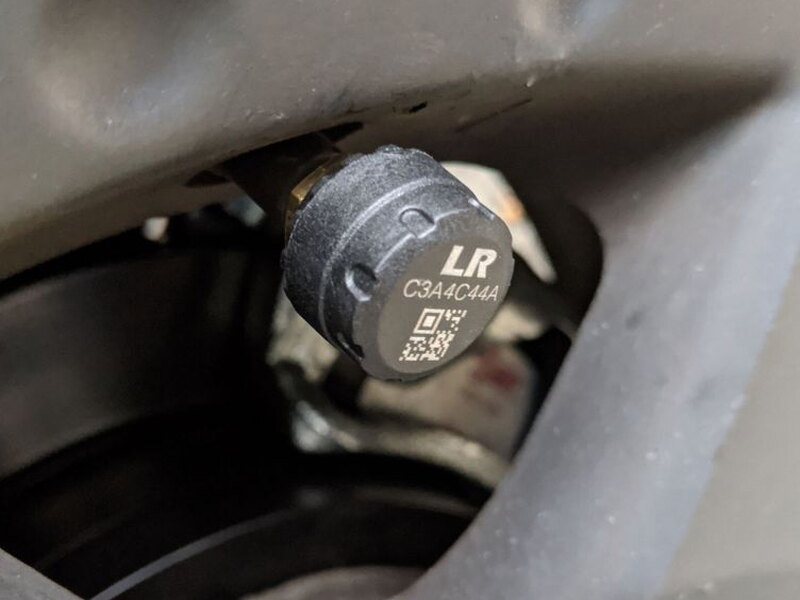 The labeled sensor cap installs onto the valve stem after the hex nut is in place.