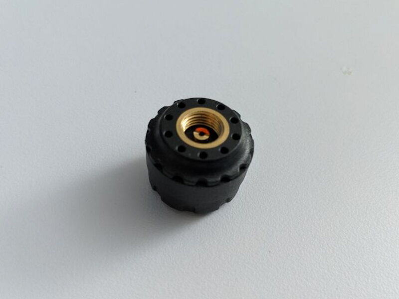 The threaded underside of a sensor screws onto the tire valve stem.