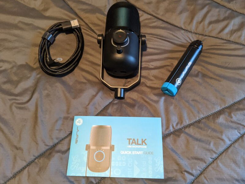 Everything in the box: the mic on its swivel stand, the braided cable, the folded tripod, and the quick start guide.
