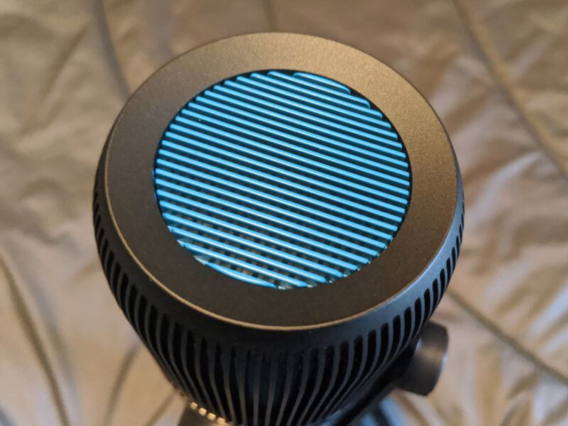 The top grille from above, blue mesh visible through the fins.