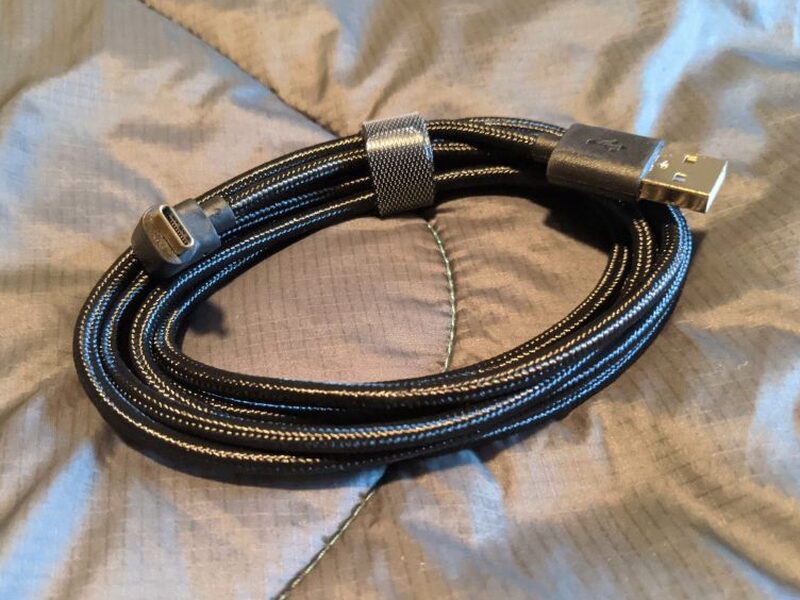 The braided USB to USB-C cable, its 90-degree connector visible at one end.