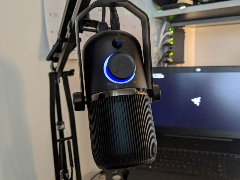 Mounted on a telescoping boom arm at the desk, the ring glowing blue.