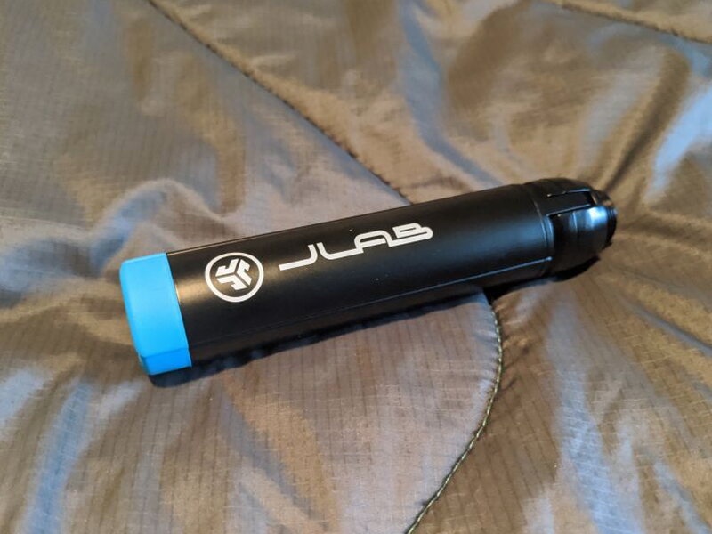 The tripod folded up, JLAB branded with a blue rubber foot.