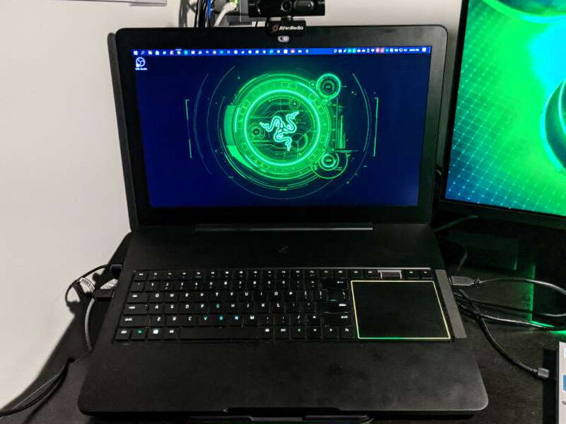 The PW315 mounted on a laptop in a home office setup.