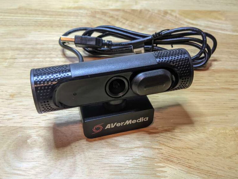 The PW315 on a desk with its attached cable coiled behind it.