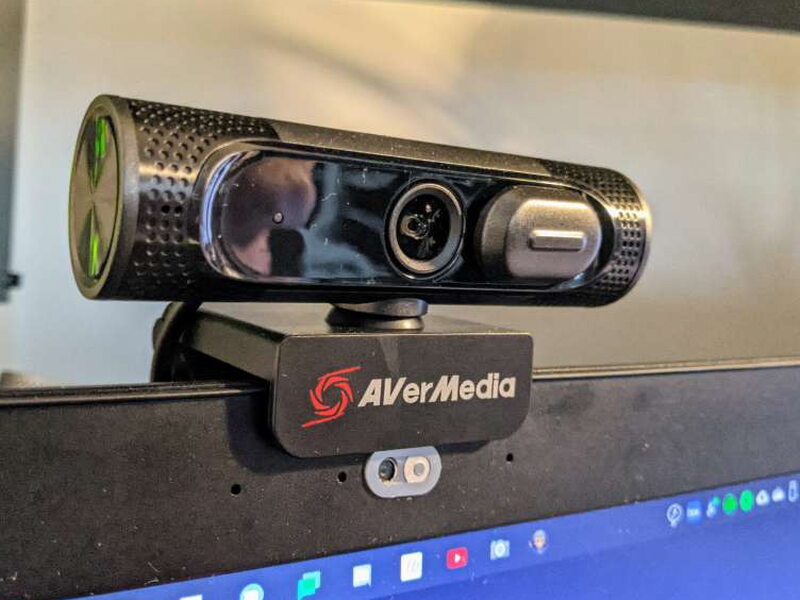 The PW315 clipped to a monitor with the lens visible during use.