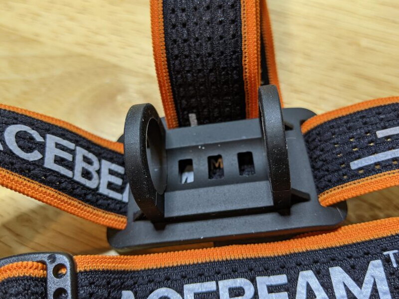 The front silicone cradle is the mount that holds the PT40 on the headband.