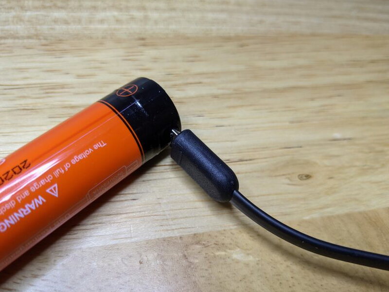 The Micro USB plug connects directly to the charging port on the battery.