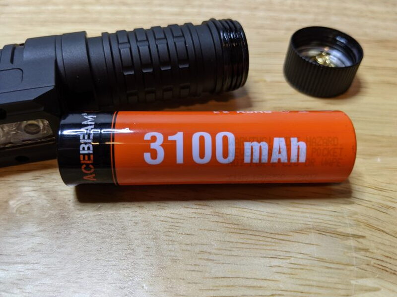 The included 3100 mAh battery sits beside the opened PT40 after the tab is removed.