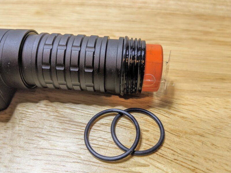 The battery compartment threads and spare O-rings help maintain the weather seal.