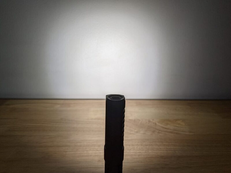 The PT40 beam spread shown against a wall in a dark room.