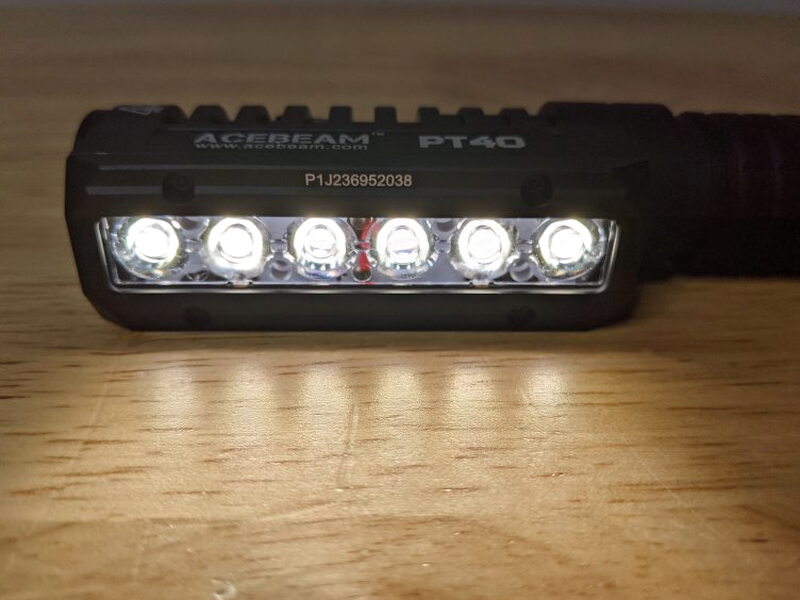 The PT40 illuminated with all six front LEDs visible in the dark.