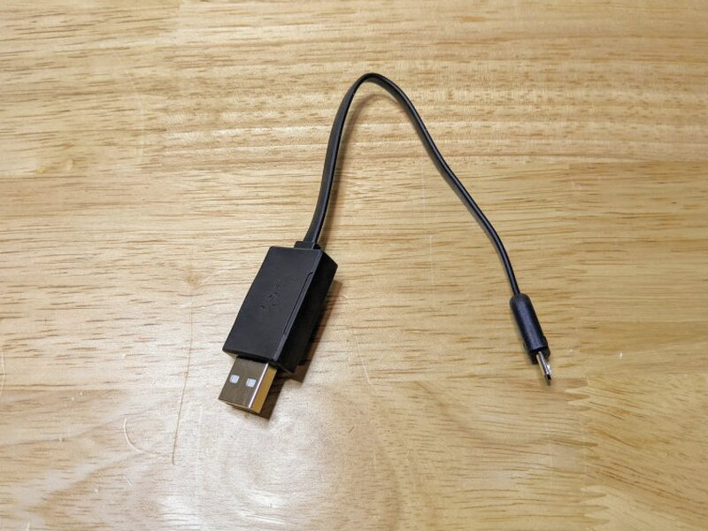 The included short USB-A to Micro USB cable charges the removable battery.