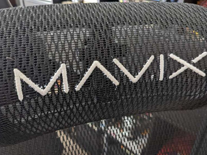 A close look at the logo stitching, with loose thread ends visible around the letters.