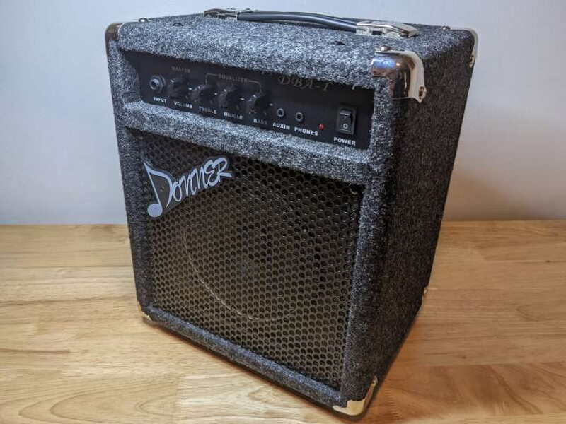 The DBA-1 is a compact practice amp with a carpeted cabinet and metal corner protectors.