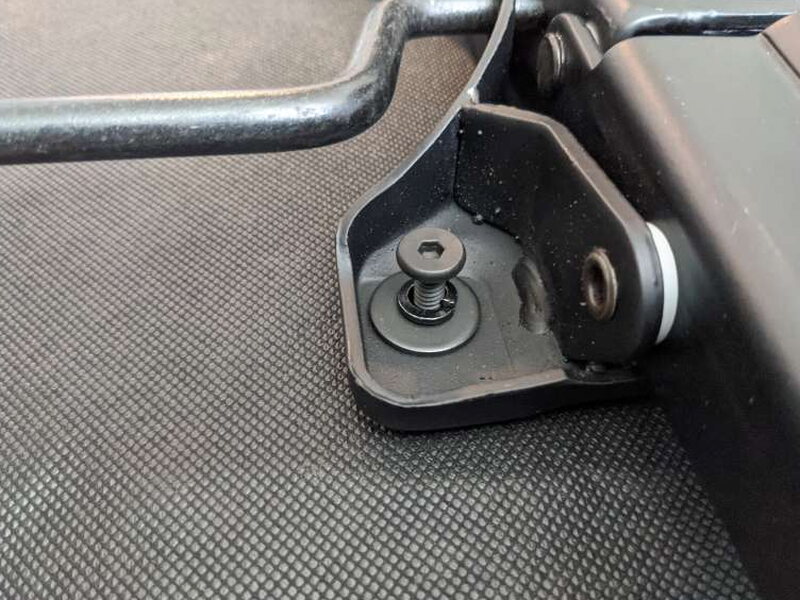 A mounting bolt with both washers stacked underneath it.